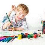 Boy painting with a brush